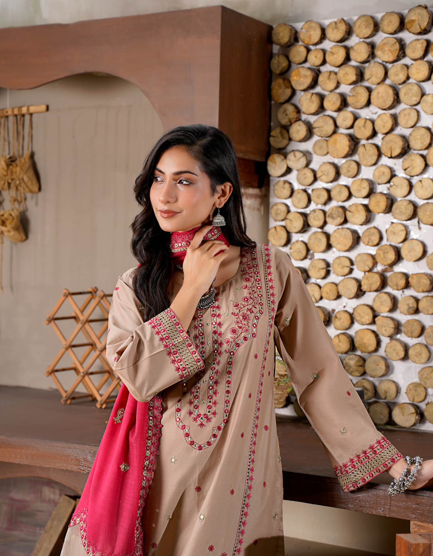 Pakistani bride in hand-embroidered taupe dress with pink dupatta